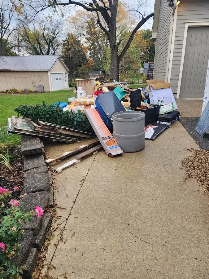 Dumpster being loaded with debris for 10 Yard Dumpster Rental in Blackman